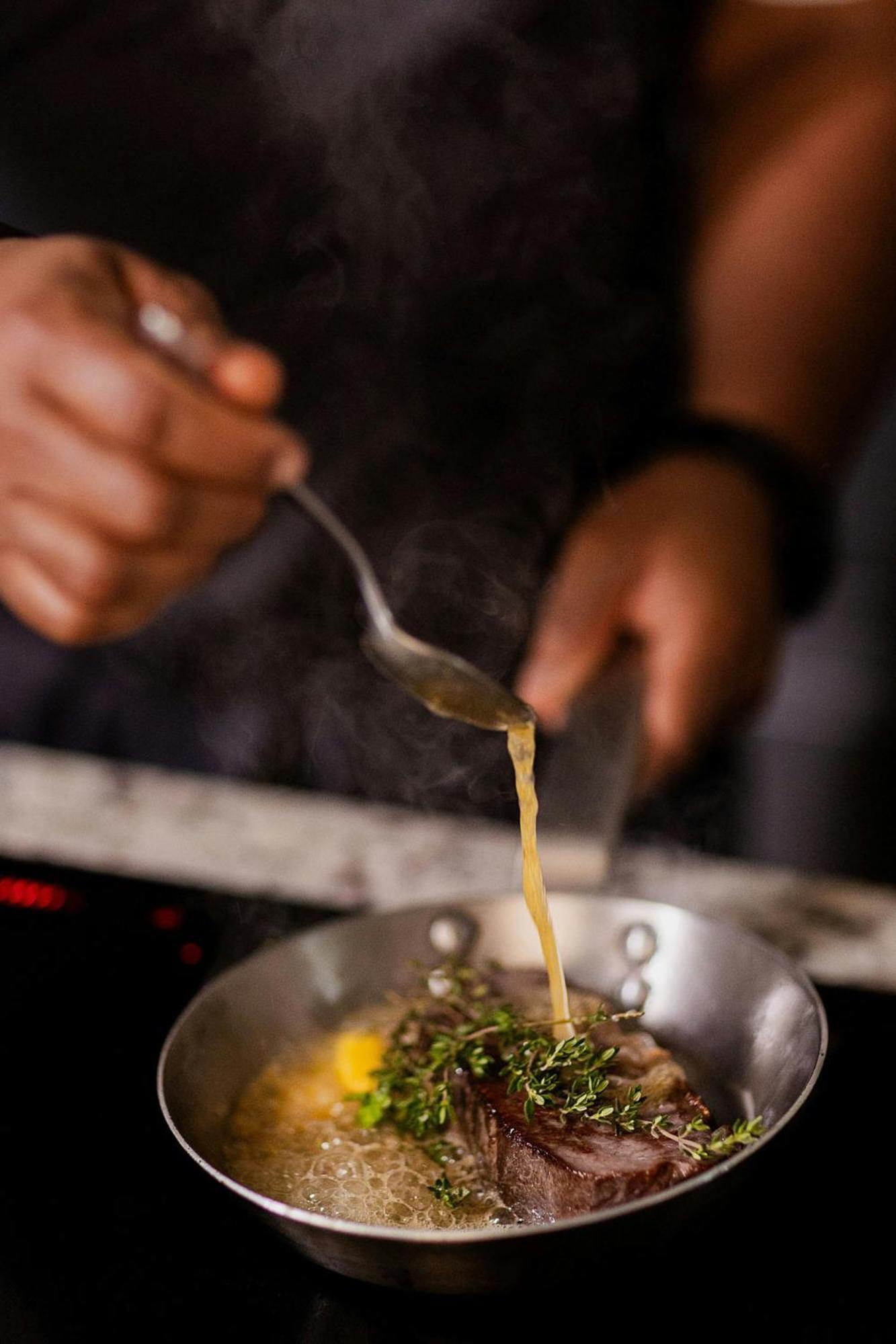 Stock Exchange Hotel, Manchester, Autograph Collection Esterno foto A chef seasoning a dish